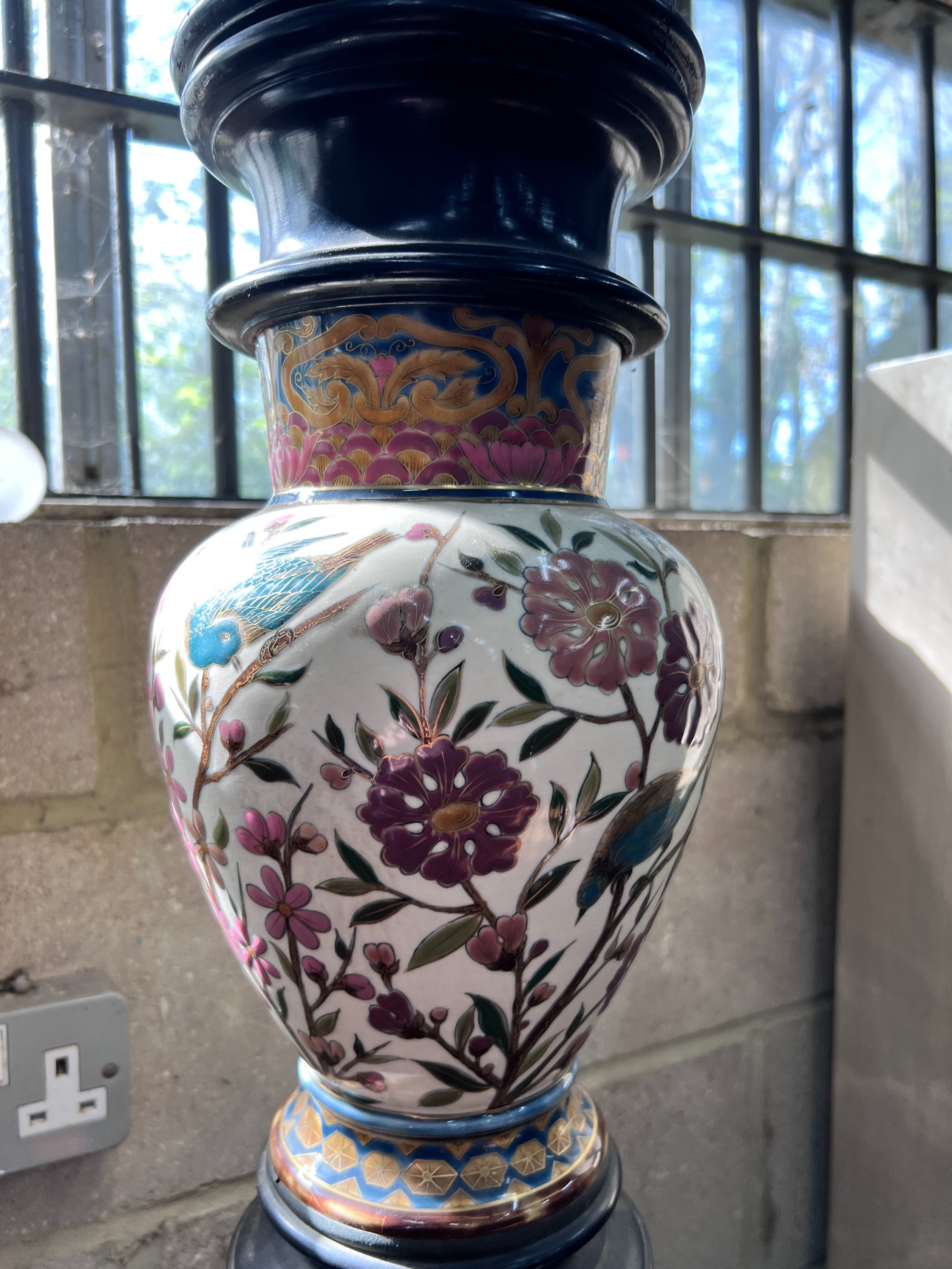 A 19th century ebonised porcelain mounted pedestal, height 105cm *Please note the sale commences at 9am.